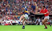2 July 2000; Eugene O'Neill of Tipperary scores despite the attention of Sean Og O'hAlipin of Cork during the Guinness Munster Senior Hurling Championship Final between Cork and Tipperary at Semple Stadium in Thurles, Tipperary. Photo by Brendan Moran/Sportsfile