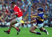 2 July 2000; Fergal Ryan of Cork in action against Eugene O'Neill of Tipperary during the Guinness Munster Senior Hurling Championship Final between Cork and Tipperary at Semple Stadium in Thurles, Tipperary. Photo by Ray McManus/Sportsfile