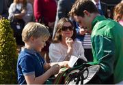 6 April 2015; Jockey Paul Townend signs an autograph for Oisin Malloy, 7, of Drogheda after winning the REA Grimes Property Consultants Hurdle. Fairyhouse Easter Festival, Fairyhouse, Co. Meath. Picture credit: Cody Glenn / SPORTSFILE