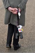 29 April 2015; A racegoer strolls through the paddock with binoculars. Punchestown Racecourse, Punchestown, Co. Kildare. Picture credit: Cody Glenn / SPORTSFILE