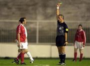 12 July 2000; Referee Wolfgang Sova shows a yellow card to Stephen Geoghegan of Shelbourne, one of five yellow card issued to Shelbourne players during the UEFA Champions League 1st Qualfiying Round 1st Leg match between Sloga Jugomagnat and Shelbourne at  air Stadium in Skopje, Macedonia. Photo by David Maher/Sportsfile