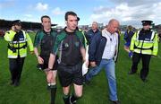 22 June 2008; Referee Eamonn Morris, 2nd from left, is confronted by Limerick manager Richie Bennis as he is escorted from the pitch by Gardai after the game. GAA Hurling Munster Senior Championship Semi-Final, Limerick v Clare, Semple Stadium, Thurles, Co. Tipperary. Picture credit: Brendan Moran / SPORTSFILE
