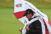 9 July 2008; Padraig Harrington takes cover from the rain during the Ladbrokes.com Irish PGA Championship, The European Club, Co. Wicklow. Picture credit: Matt Browne / SPORTSFILE