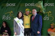 21 May 2015; Lukas Postlberger, Tirol Cycling Team, after receiving the An Post Rás Yellow Jersey Classification from Miss An Post Rás Donna McCaffrey and Finbar Langan, Delivery Services Manager, An Post, Ballina, following Stage 5 of the 2015 An Post Rás. Newport - Ballina. Photo by Sportsfile