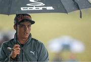 29 May 2015; Rickie Fowler, USA, shelters from the rain on the 9th green. Dubai Duty Free Irish Open Golf Championship 2015, Day 2. Royal County Down Golf Club, Co. Down. Picture credit: Brendan Moran / SPORTSFILE
