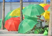 2 August 2008; A performer shields himself while waiting in the sun before rehearsals for the Opening Ceremony on Friday the 8th. Preparations continue ahead of the Games which start on Saturday the 9th of August. Beijing 2008 - Games of the XXIX Olympiad, Olympic Green, Beijing, China. Picture credit: Brendan Moran / SPORTSFILE