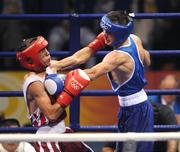 8 August 2008; John Joe Nevin, Ireland, scores a point during his bout with Abdelhalim Ourradi, from Algeria, in red, during the 1 of 16 preliminaires of the Bantam weight, 54 kg, contest. Nevin won 9pts to 4. Beijing 2008 - Games of the XXIX Olympiad, Beijing Workers Gymnasium, Olympic Green, Beijing, China. Picture credit: Ray McManus / SPORTSFILE