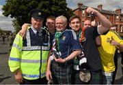 13 June 2015; Scotland supporters pose for a picture with Sergent Neil Randles, from Pearse Street Garda station ahead of the game. UEFA EURO 2016 Championship Qualifier, Group D, Republic of Ireland v Scotland, Aviva Stadium, Lansdowne Road, Dublin. Picture credit: Ray McManus / SPORTSFILE