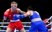 16 June 2015; Kurt Walker, Ireland, left, exchanges punches with Nazirov Bakhtovar, Russia, during their Men's Boxing Bantam 56kg Round of 32 bout. 2015 European Games, Crystal Hall, Baku, Azerbaijan. Picture credit: Stephen McCarthy / SPORTSFILE