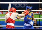 22 August 2008; Paddy Barnes, Ireland, lands a punch on Zou Sheming, in blue, China, but no point was awarded by the judges, during the first round of their semi-final bout in the Light Fly weight, 48kg, contest. Beijing 2008 - Games of the XXIX Olympiad, Beijing Workers' Gymnasium, Olympic Green, Beijing, China. Picture credit: Brendan Moran / SPORTSFILE