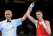 19 June 2015; Brendan Irvine, Ireland, is declared victorious by referee Referee Tariel Gogotchuri following his Men's Boxing Light Fly 49kg Round of 16 bout with Tinko Banabakov, Bulgaria. 2015 European Games, Crystal Hall, Baku, Azerbaijan. Picture credit: Stephen McCarthy / SPORTSFILE