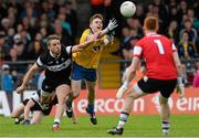 20 June 2015; Cian Connolly, Roscommon, scoring a point dispite the attentions of Daniel Maye, Sligo. Connacht GAA Football Senior Championship, Semi-Final, Sligo v Roscommon, Markievicz Park, Sligo. Picture credit: Oliver McVeigh / SPORTSFILE