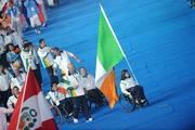 6 September 2008; Flag bearer Patrice Dockery, from Swords, Dublin, who competes in the Wheelchair 100m, 200m, & 400m leads the Ireland team out during the Opening Ceremony of the Beijing Paralympic Games 2008, National Stadium, Olympic Green, Beijing, China. Picture credit: Brian Lawless / SPORTSFILE