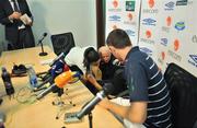 9 September 2008; Republic of Ireland manager Giovanni Trapattoni is helped back to his feet by translator Manuela Spinelli and captain Robbie Keane after accidentally falling back off his chair before the start of the press conference. City Stadium, Podgorica, Montenegro. Picture credit; David Maher / SPORTSFILE