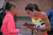 7 July 2015; Abbey D'Agostino, USA, signs an autograph for a young fan after the women's 3000m at the Cork City Sports 2015. CIT, Bishopstown, Cork. Picture credit: Eoin Noonan / SPORTSFILE