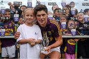 8 July 2015; Felicja Davis, aged 7, Enniscorthy, presents Wexford's Conor McDonald with the man of the match award after the game. Bord Gáis Energy Leinster GAA Hurling U21 Championship Final, Wexford v Kilkenny. Innovate Wexford Park, Wexford. Picture credit: Piaras Ó Mídheach / SPORTSFILE