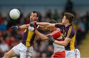 11 July 2015; Caolan O'Boyle, Derry, in action against Joey Wadding and Nathan Rossiter, Wexford. GAA Football All-Ireland Senior Championship, Round 2B, Derry v Wexford, Owenbeg, Derry. Picture credit: Oliver McVeigh / SPORTSFILE