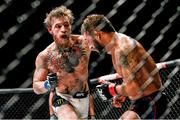 11 July 2015; Conor McGregor, left, in action against Chad Mendes during their Interim UFC Featherweight Championship Title bout at UFC 189. MGM Grand Garden Arena, Las Vegas, USA. Picture credit: Esther Lin / SPORTSFILE