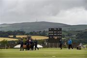 12 July 2015; Groundstaff prepare to cover the crease as play is delayed due to weather before the start of the game between  PNG and Jersey. ICC World Twenty20 Qualifier 2015, PNG v Jersey, Bready, Co. Tyrone. Picture credit: David Maher / ICC / SPORTSFILE