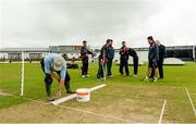 13 July 2015; Groundsman David Caldwell prepares the wicket as Hong Kong Players watch on due to a delayed start. ICC World Twenty20 Qualifier 2015,Hong Kong v PNG, Bready, Co. Tyrone. Picture credit: Oliver McVeigh / ICC / SPORTSFILE