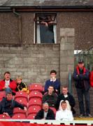 17 September 2000; Spectator in his house over looking the ground watches the game during the Eircom League Premier Division match between Cork City and Derry City at Turners Cross in Cork. Photo by David Maher/Sportsfile