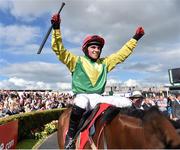 29 July 2015; Jonathan Burke celebrates in the parade ring on Shanahan's Turn after winning the thetote.com Galway Plate. Galway Racing Festival, Ballybrit, Galway. Picture credit: Cody Glenn / SPORTSFILE