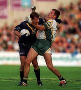 8 October 2000; Mark Ricciuto of Australia is tackled by Anthony Tohill of Ireland during the International Rules Series First Test match between Ireland and Australia at Croke Park in Dublin. Photo by Ray McManus/Sportsfile