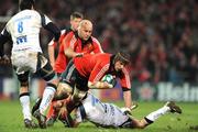 16 January 2009; Alan Quinlan, Munster, accompanied by team-mate John Hayes, is tackled by Neil Briggs, Sale Sharks. Heineken Cup, Pool 1, Round 5, Munster v Sale Sharks, Thomond Park, Limerick. Picture credit: Brendan Moran / SPORTSFILE