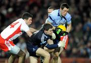 31 January 2009; Dublin full-back Donncha Bastick, supported by keeper Stephen Cluxton, wins possession from Tyrone's Sean Cavanagh. Allianz National Football League, Division 1, Round 1, Dublin v Tyrone, Croke Park, Dublin. Picture credit: Ray McManus / SPORTSFILE