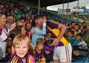 22 August 2015; Tony French, Wexford, celebrates with his mother Anne after the game.  Bord Gáis Energy GAA Hurling All Ireland U21 Championship, Semi-Final, Wexford v Antrim. Semple Stadium, Thurles, Co. Tipperary. Picture credit: Ray McManus / SPORTSFILE