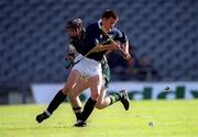 15 October 2000; Ian Borthwick of Scotland in action against DJ Carey of Ireland during the Hurling Shinty International match between Ireland and Scotland at Croke Park in Dublin. Photo by Ray McManus/Sportsfile