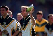 15 October 2000; Ireland captain DJ Carey celebrates with the cup folloowing his side's victory during the Hurling Shinty International match between Ireland and Scotland at Croke Park in Dublin. Photo by Ray McManus/Sportsfile