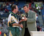 15 October 2000; Ireland captain DJ Carey, left, is presented with the Cup by GAA President Sean McCague during the Hurling Shinty International match between Ireland and Scotland at Croke Park in Dublin. Photo by Brendan Moran/Sportsfile