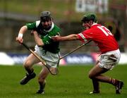 22 October 2000; Paidi Reade of Limerick in action against Eoin Fitzgerald of Cork during the Waterford Crystal South East Hurling League match between Limerick and Cork at Gaelic Grounds in Limerick. Photo by Damien Eagers/Sportsfile