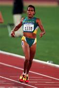 22 September 2000; Cathy Freeman of Australia on her way to winning her Women's 400m heat at Stadium Australia in the Sydney Olympic Park in Homebush Bay, Sydney, Australia. Photo by Brendan Moran/Sportsfile