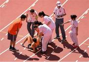 27 August 2015; Maureen Koster of the Netherlands receives medical assistance during round 1 of the Women's 5000m event. IAAF World Athletics Championships Beijing 2015 - Day 6, National Stadium, Beijing, China. Picture credit: Stephen McCarthy / SPORTSFILE