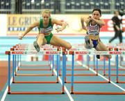 6 March 2009; Derval O'Rourke, Ireland, clears the last hurdle ahead of Elisabeth Davin, of Belgium, on her way to winning her heat in the Women's 60m hurdles. European Indoor Athletics Championships, Oval Lingotto, Torino, Italy. Picture credit: Brendan Moran / SPORTSFILE