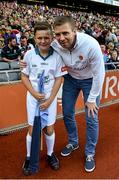 5 September 2015; eircom GAA Flagbearer Jordan O'Reilly, age 10, a member of Tomas Davis GAA Club, Tallaght, Co. Dublin, pictured with eircom ambassador Tomás Ó Sé at the All-Ireland Senior Football Semi-final replay between Dublin and Mayo. Croke Park, Dublin. Picture credit: Ray McManus / SPORTSFILE