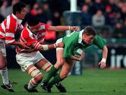 11 November 2000; Ronan O'Gara of Ireland is tackled by Hiroyuki Tanuma of Japan during the International Rugby friendly match between Ireland and Japan at Lansdowne Road in Dublin. Photo by Ray Lohan/Sportsfile