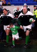 11 November 2000;  Ireland team captain, Keith Wood, leads the Irish team with mascot Luke Clohessy ahead of the International Rugby friendly match between Ireland and Japan at Lansdowne Road in Dublin. Photo by Ray Lohan/Sportsfile