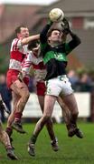 12 December 2000; Kevin Cahill of Nemo Rangers wins this high ball ahead of Timmy Connelly, centre, and Barry Delargy of Tir Chonnaill Gaels during the All-Ireland Club Football Quarter Final match between Tir Chonnaill Gaels and Nemo Rangers at Pairc Smargaid, Ruislip in London, England. Photo by Brendan Moran/Sportsfile