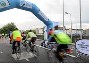 13 September 2015; The Irish Sports Council, in conjunction with Cycling Ireland teamed up with the Department of Transport, Tourism and Sport, Dublin City Council and Healthy Ireland for the Great Dublin Bike Ride which seen over 3,000 participants of all abilities from novice to expert ride 60km or 100km routes. Pictured are participants as they cycle under the start banner. The Great Dublin Bike Ride. Smithfield Square, Dublin. Picture credit: Seb Daly / SPORTSFILE