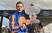 13 September 2015; Joseph O'Brien hoists the trophy after riding Order Of St. George to victory in the Palmerstown House Estate Irish St. Leger. Irish Champions Weekend. The Curragh, Co. Kildare. Picture credit: Cody Glenn / SPORTSFILE