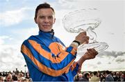 13 September 2015; Joseph O'Brien hoists the trophy after riding Order Of St. George to victory in the Palmerstown House Estate Irish St. Leger. Irish Champions Weekend. The Curragh, Co. Kildare. Picture credit: Cody Glenn / SPORTSFILE