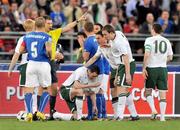 1 April 2009; Republic of Ireland's John O'Shea lies injured as referee Wolfgang Stark sends off Giampaolo Pazzini, Italy. 2010 FIFA World Cup Qualifier, Italy v Republic of Ireland, San Nicola Stadium, Bari, Italy. Picture credit: David Maher / SPORTSFILE