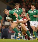 19 September 2015; Ian Madigan, Ireland, is tackled by Brett Beukeboom, Canada. 2015 Rugby World Cup, Pool D, Ireland v Canada. Millennium Stadium, Cardiff, Wales. Picture credit: Brendan Moran / SPORTSFILE
