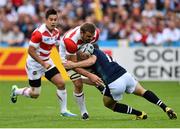 23 September 2015; Michael Broadhurst, Japan, is tackled by Matt Scott, Scotland. 2015 Rugby World Cup, Pool B, Scotland v Japan. Kingsholm Stadium, Gloucester, England. Picture credit: Ramsey Cardy / SPORTSFILE