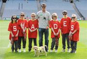 30 April 2009; Recently appointed Ipswich Town manager and Irish soccer legend Roy Keane with puppy in training Ella and schoolchildren, from left, Emily O'Connell, age 11, from Blakestown, Dublin, Roisin Ni Chaoimh, age 12, from Blanchardstown, Dublin, Adam Fagan, age 10, from Rathoath, Co. Meath, Rebecca Nic Liam, age 9, from Clonsilla, Dublin, Cian O Ceallaigh, age 12, from Castleknock, Dublin and Caoimhe Ryan, age 11, from Castleknock, Dublin, at the official launch of the seventh annual Irish Guide Dogs for the Blind Specsavers Shades 2009 campaign. The campaign raises funds for the training of guide and assistant dogs and centres around a week of fundraising nationwide which kicks off on Monday 4th May 2009. Croke Park, Dublin. Picture credit: Brendan Moran / SPORTSFILE