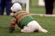 31 December 2000; Jockey Charlie Swan on the ground after falling from Istabraq in the The AIB Agri Business December Festival Hurdle during day three of the Christmas Festival at Leopardstown Racecourse in Dublin. Photo by Aoife Rice/Sportsfile