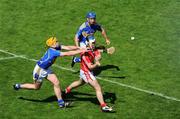 31 May 2009; Kieran Murphy, Cork, shoots under pressure from Padraic Maher and Conor O'Brien, no.4, Tipperary. Munster GAA Hurling Senior Championship Quarter-Final, Tipperary v Cork, Semple Stadium, Thurles, Co. Tipperary. Picture credit: Ray McManus / SPORTSFILE